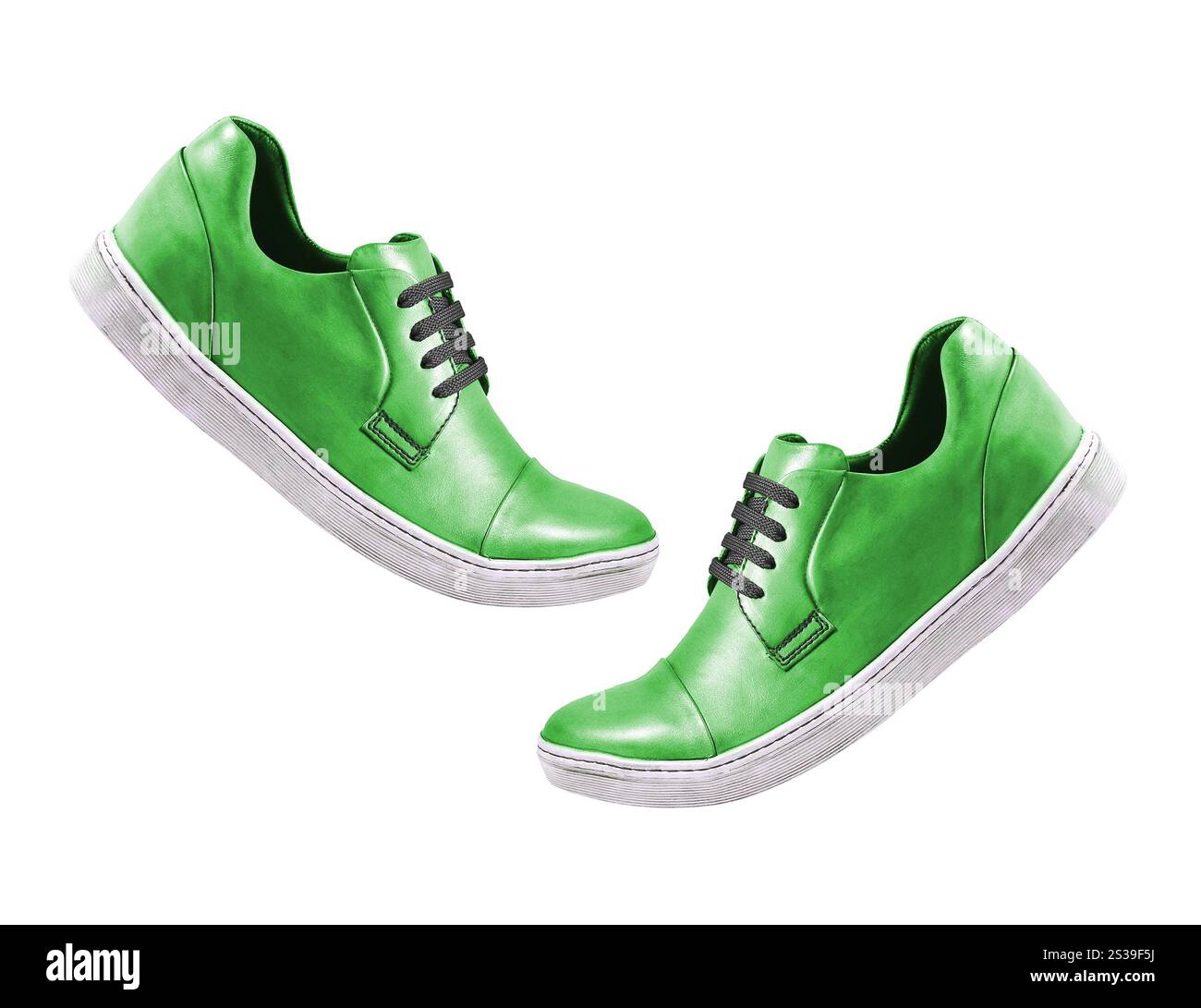 Grüner Sportschuh isoliert auf einem Weißen. Blauer Sportschuh isoliert auf einem Weißen Stockfoto