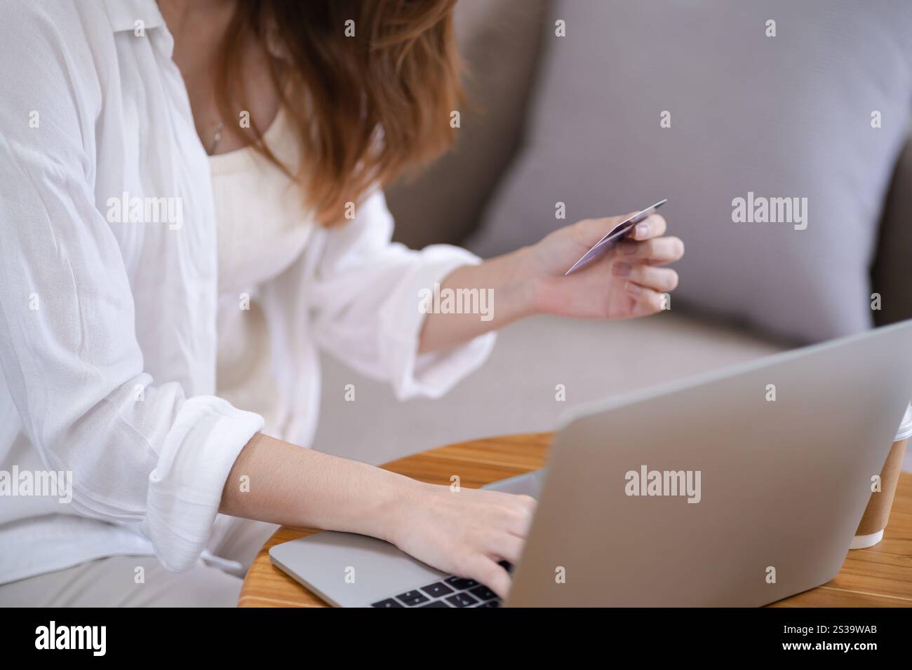 Frau, die auf einem Laptop mit Kreditkarte für Internet Online-E-Commerce-Einkaufen Geld ausgeben Online-Einkaufen Handy-Laptop-Technologie Stockfoto