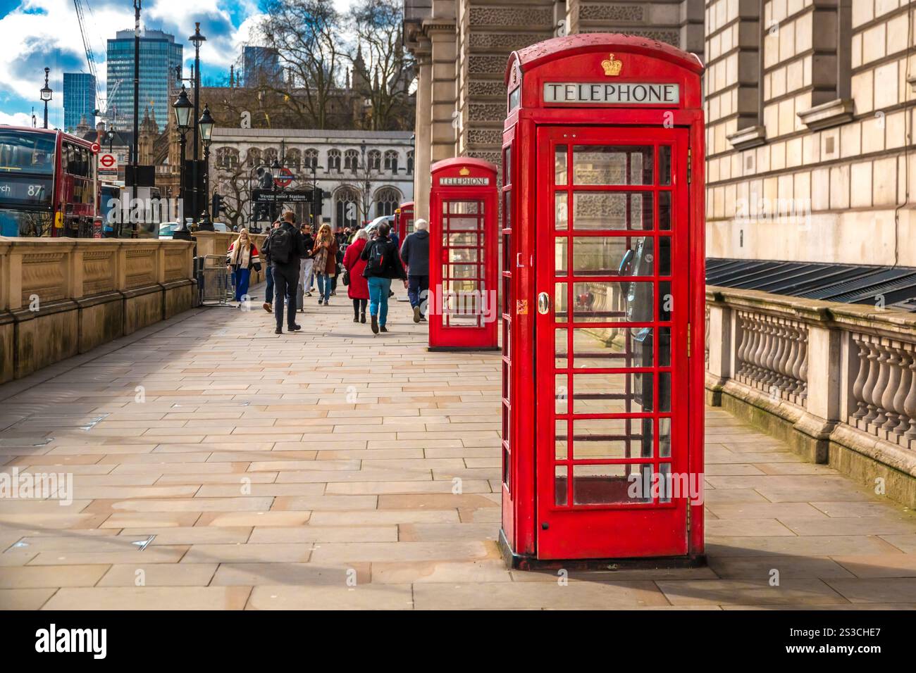 Großartiges Bild von zwei ikonischen roten K6-Telefondosen in der Parliament Street in Richtung Westminster Abbey in London, England. Das traditionelle britische Telefon... Stockfoto