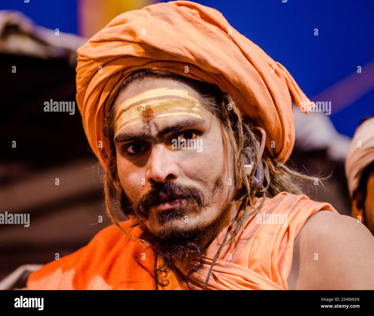 Älterer Mann in traditioneller Kleidung bei einem lebhaften Kulturfestival in Indien an einem sonnigen Tag Stockfoto