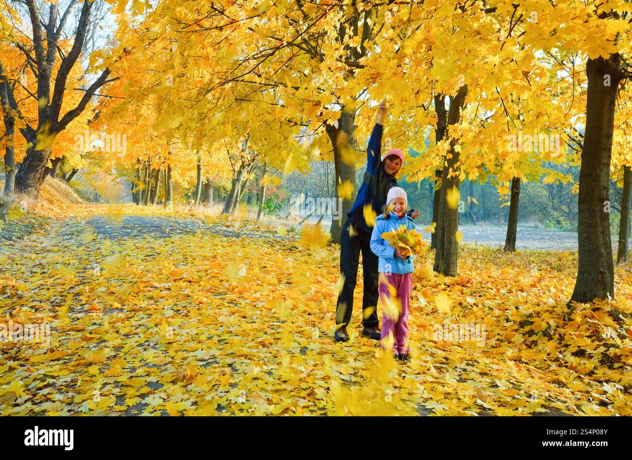 Glückliche Familie (Mutter mit Tochter) zu Fuß in goldener Ahorn Herbst park Stockfoto