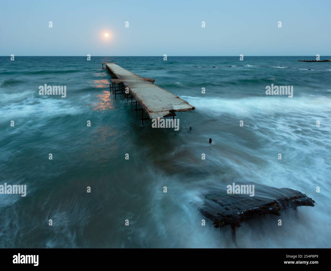 Nachtansicht Meer Surfen, zerstörte Pier und Mond Himmel (Schwarzes Meer, Bulgarien). Stockfoto