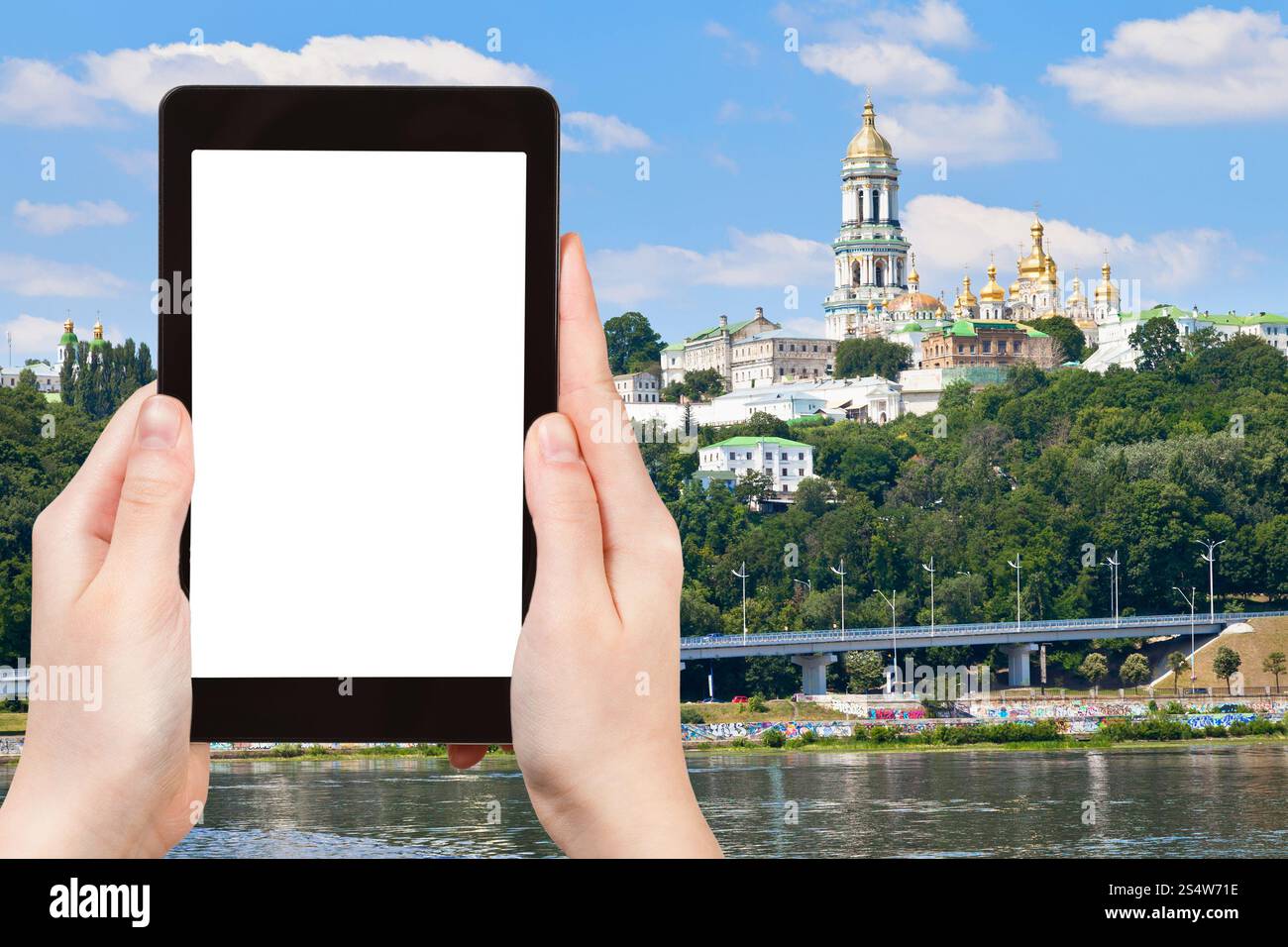 Reisekonzept - Touristenfotografie am Fluss von Kiew Petschersk Lavra, Kiew, Ukraine auf Tablet-pc mit ausgeschnittenem Bildschirm mit leerem Platz für Stockfoto