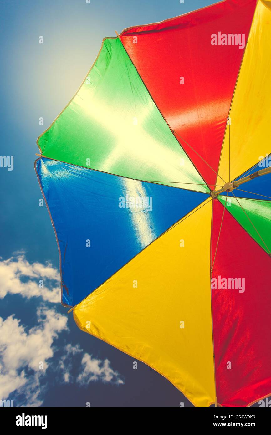 Getönten Foto von bunten Regenschirm gegen blauen Himmel Stockfoto Getönten Foto von bunten Regenschirm gegen blauen Himmel Stockfoto