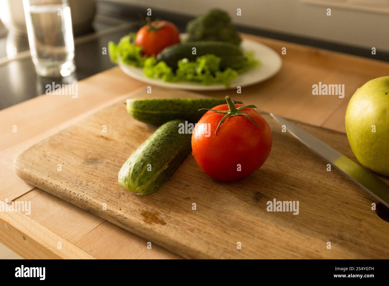 Farbfoto von Gemüse und Früchten, die auf Holzbrett in der Küche liegen Stockfoto