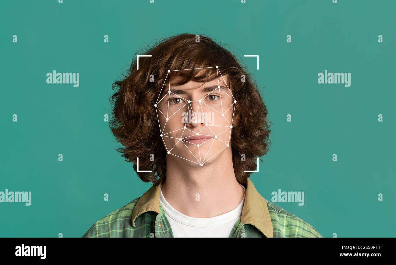 Ein junger Mann mit lockigen Haaren steht vor einem grünen Hintergrund Stockfoto