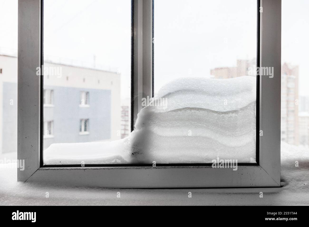 Snowdrift zwischen Fensterscheiben von Wohn- Haus in Moskau Stadt im Winter Stockfoto