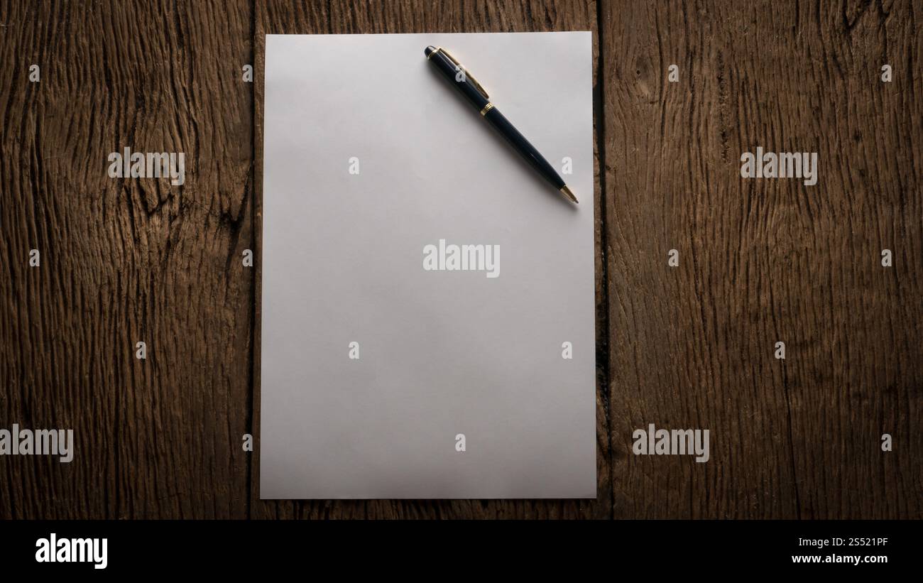 Leeres Blatt Papier und Stift auf Holztisch. Leeres Blatt Papier und Stift auf Holztisch. Stockfoto