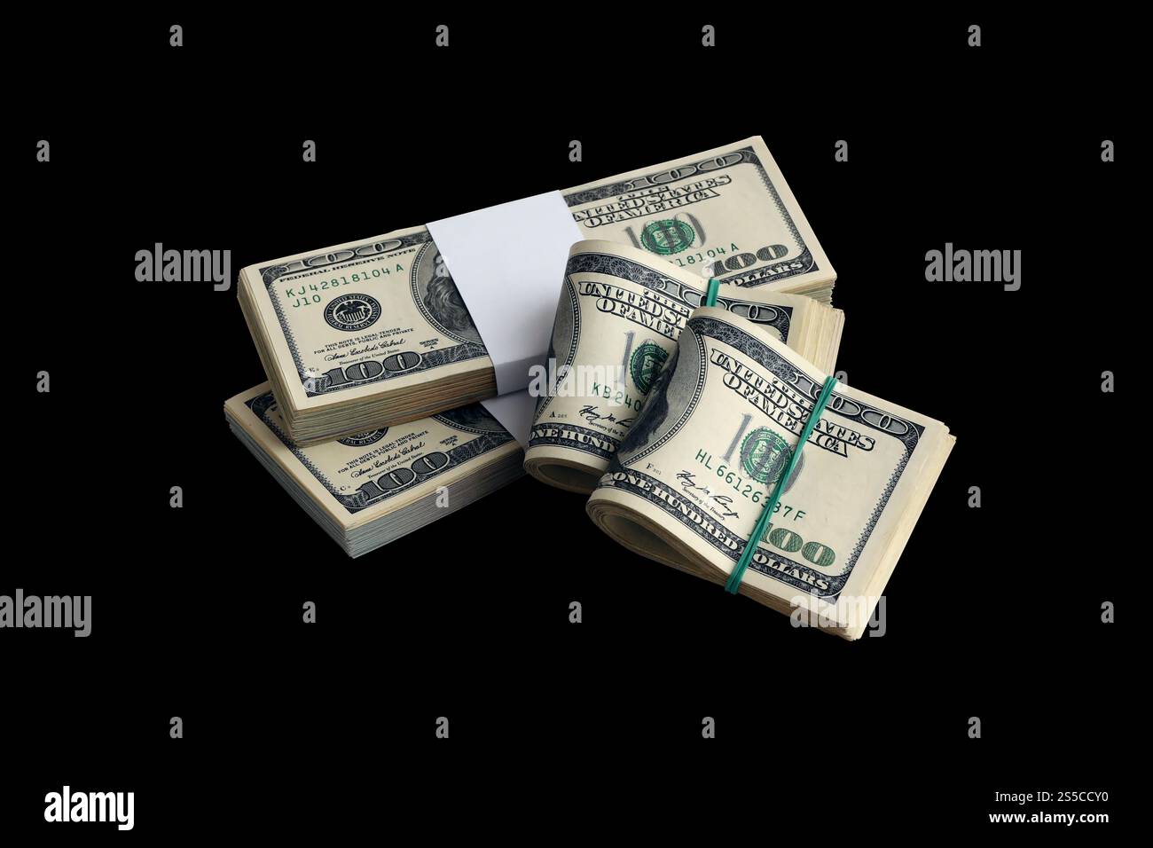 Zwei Bitcoins liegen auf einem Stapel von Dollarscheinen auf dem Hintergrund eines Monitors, der einen Binärcode aus hellgrünen Nullen und eine Einheit auf einem schwarzen zeigt Stockfoto