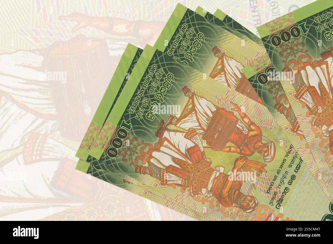 1000 Sri-lankische Rupien-Scheine liegen im Stapel auf dem Hintergrund großer halbtransparenter Banknoten. Abstrakte Darstellung der Landeswährung. Unternehmen Stockfoto