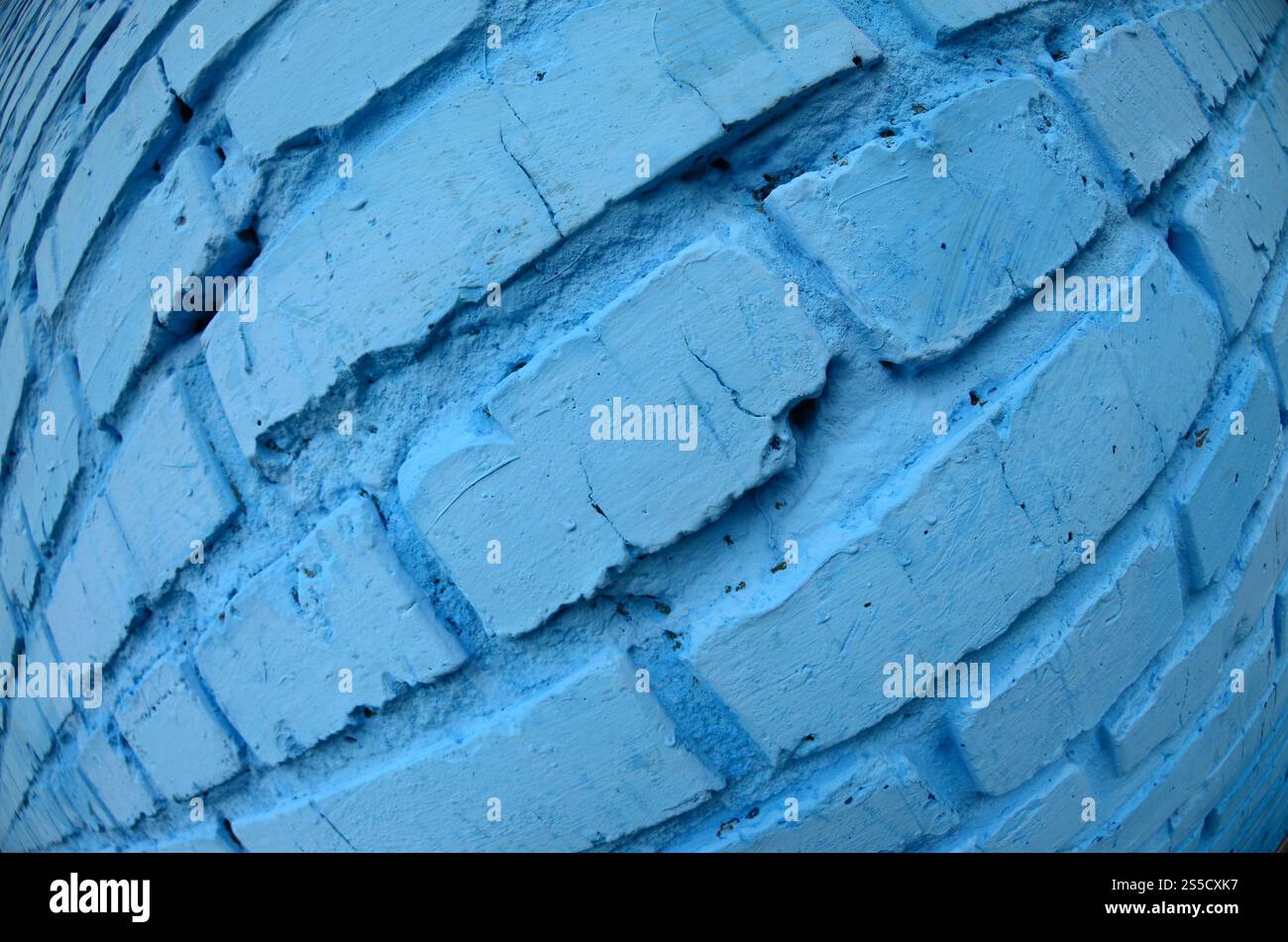 Große Backsteinwand, blau gestrichen. Fischaugenfoto mit ausgeprägter Verzerrung Stockfoto
