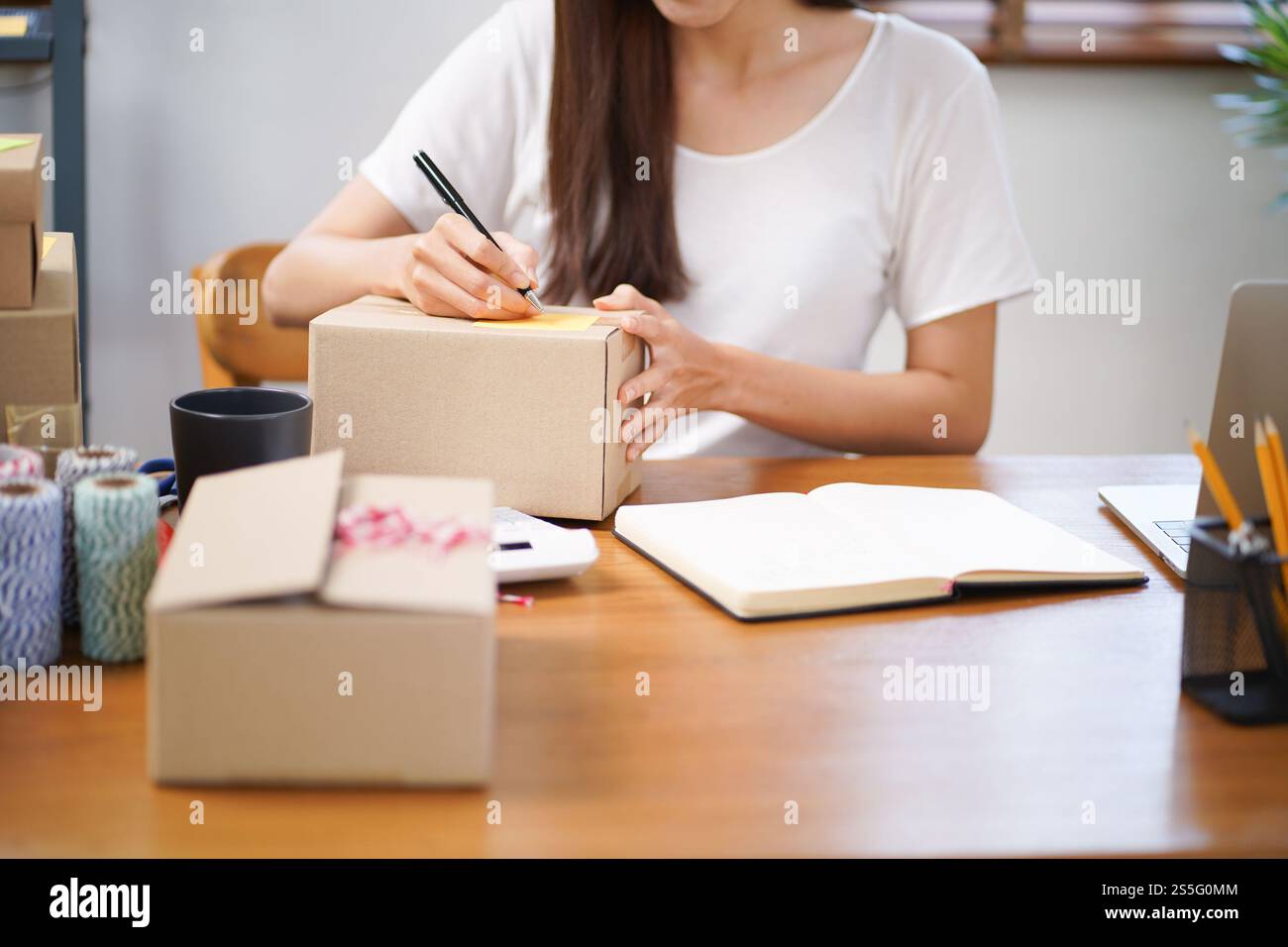 Asiatische Frau, die Paketzustellbox vorbereitet Versand für den Einkauf Online-Zustellung Postservice Menschen und Versandkonzept. Stockfoto
