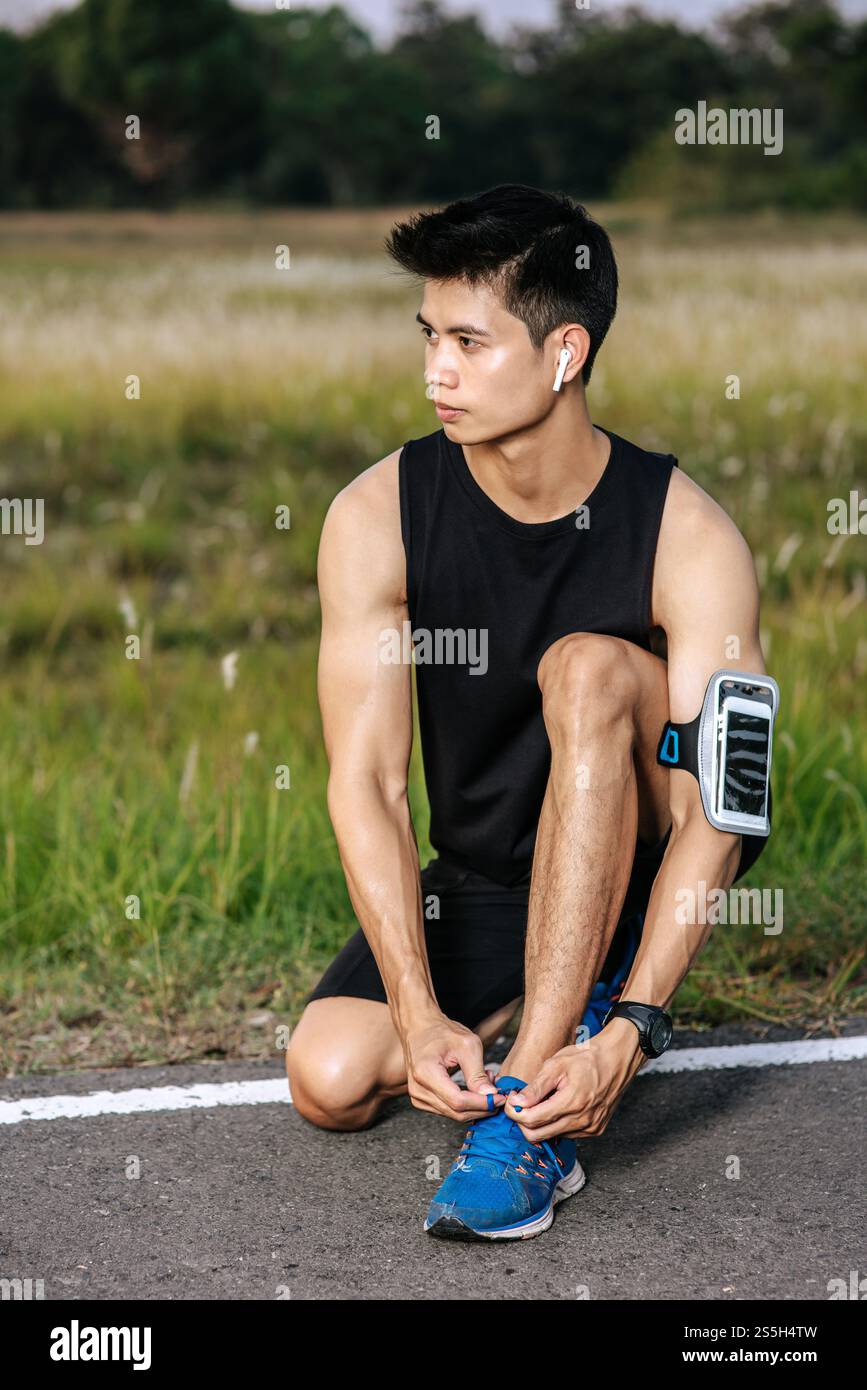 Der Mann schnürte sich einen Schnürsenkel, um zu trainieren. Selektiver Fokus. Stockfoto