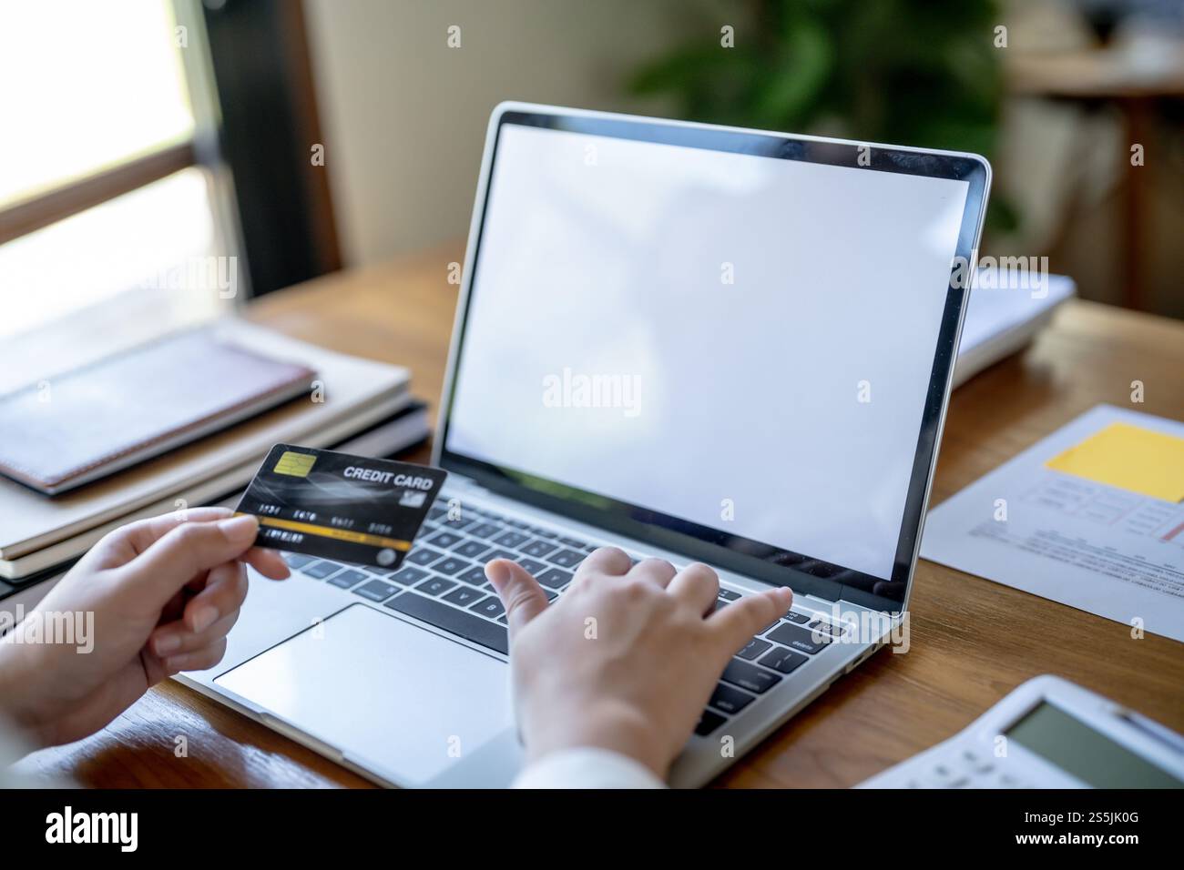Frau, die auf einem Laptop mit Kreditkarte für Internet Online-E-Commerce-Einkaufen Geld ausgeben Online-Einkaufen Handy-Laptop-Technologie Stockfoto