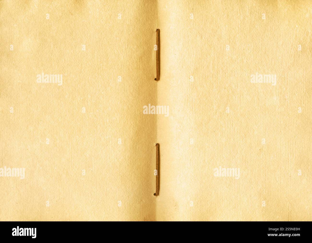 Altes offenes mittelalterliches Buch mit abgenutzten Pergamentblättern. Leeres strukturiertes Manuskript, Kopierraum. Altes offenes mittelalterliches Buch mit abgenutzten Pergamentblättern Stockfoto