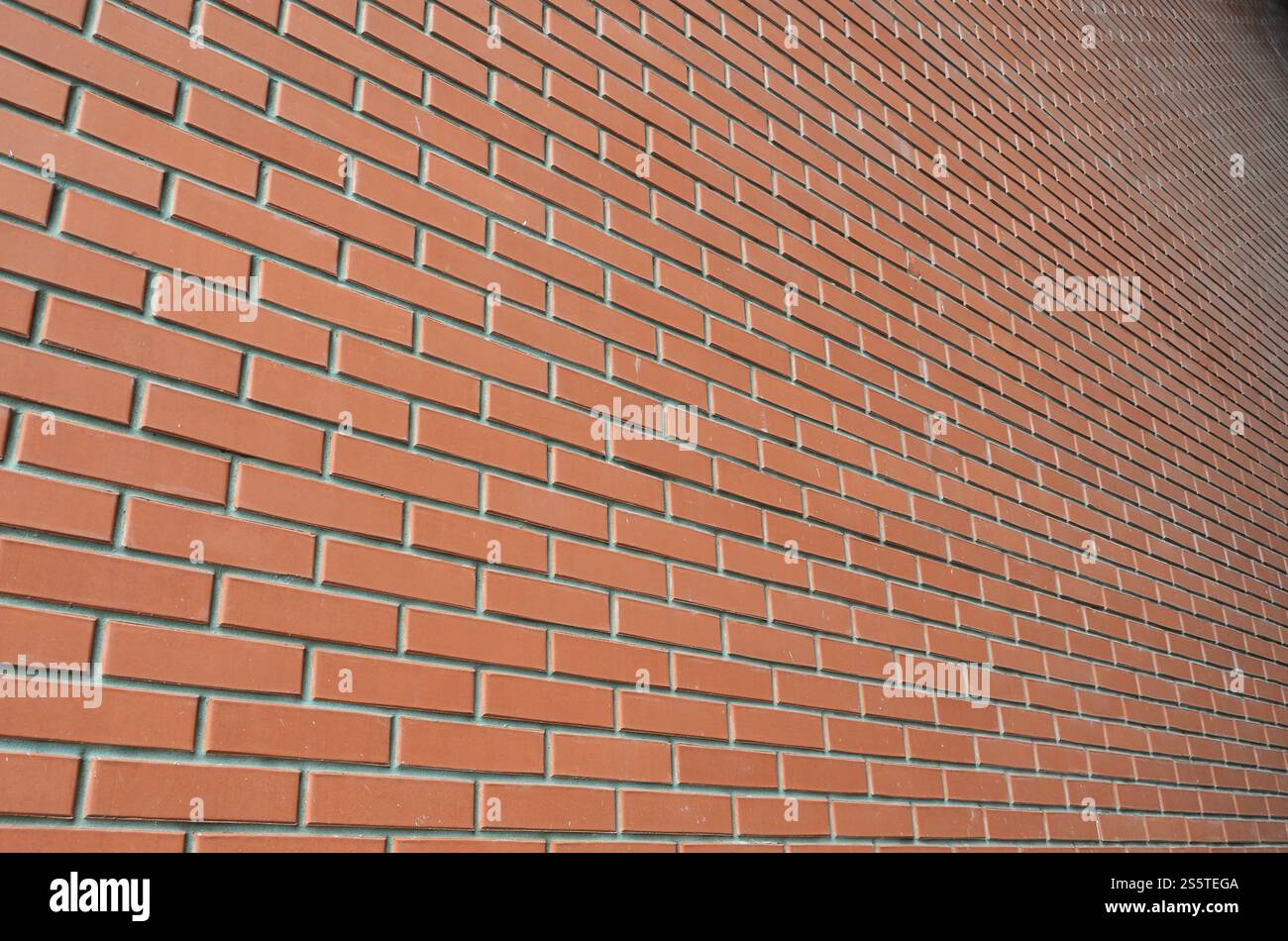 Die Textur einer hohen Mauer von einem viele Zeilen aus roten Ziegeln Stretching in Sicht Stockfoto