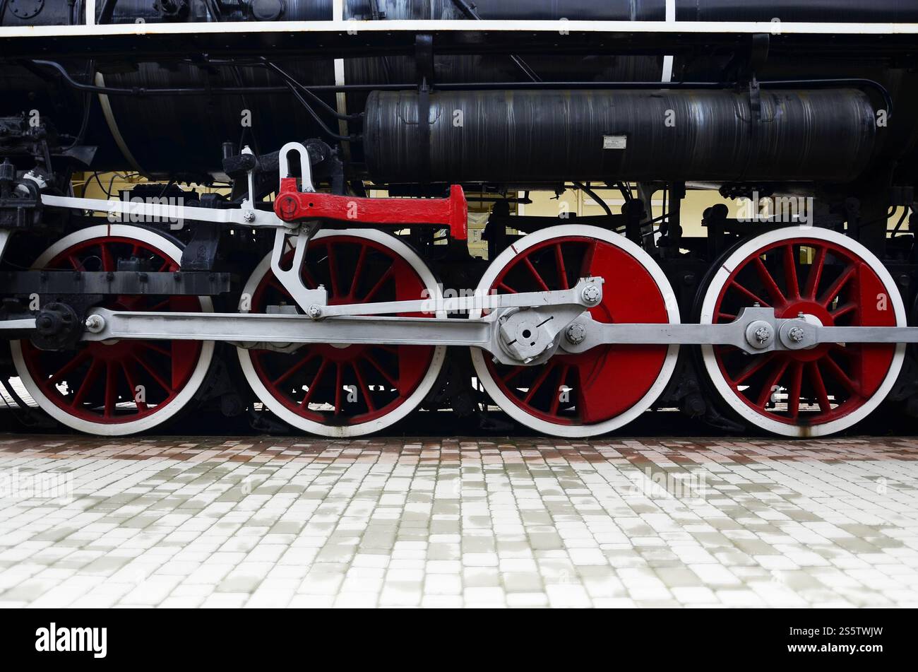 Rote Räder der alten schwarzen Dampflokomotive der UdSSR. Räder einer alten sowjetischen Dampfeisenbahn. Rote Räder der Dampfeisenbahn Stockfoto