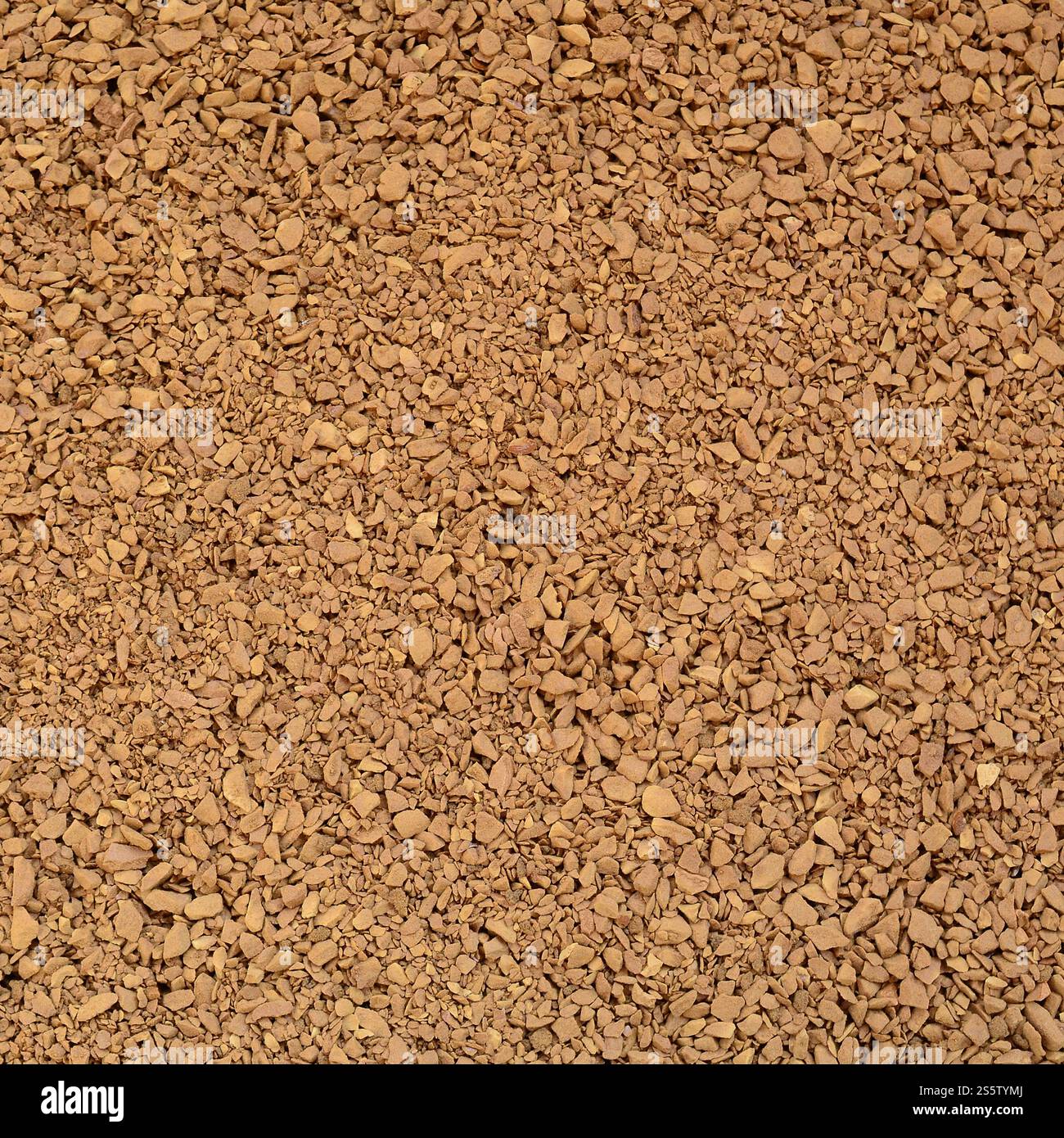 Textur des gemahlenen Kaffees in Form von vielen kleinen, dunkelbraunen Kieseln Stockfoto