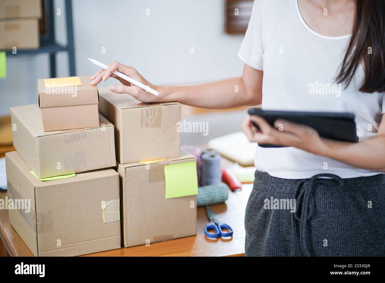 Asiatische Frau, die Paketzustellbox vorbereitet Versand für den Einkauf Online-Zustellung Postservice Menschen und Versandkonzept. Stockfoto