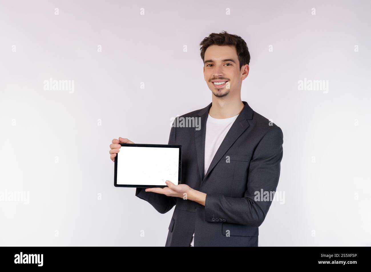 Porträt eines attraktiven, fröhlichen Geschäftsmannes, der mit einer App im Internet lokalisiert über weißem Hintergrund sucht. Technologie und Geschäftskonzept. Stockfoto