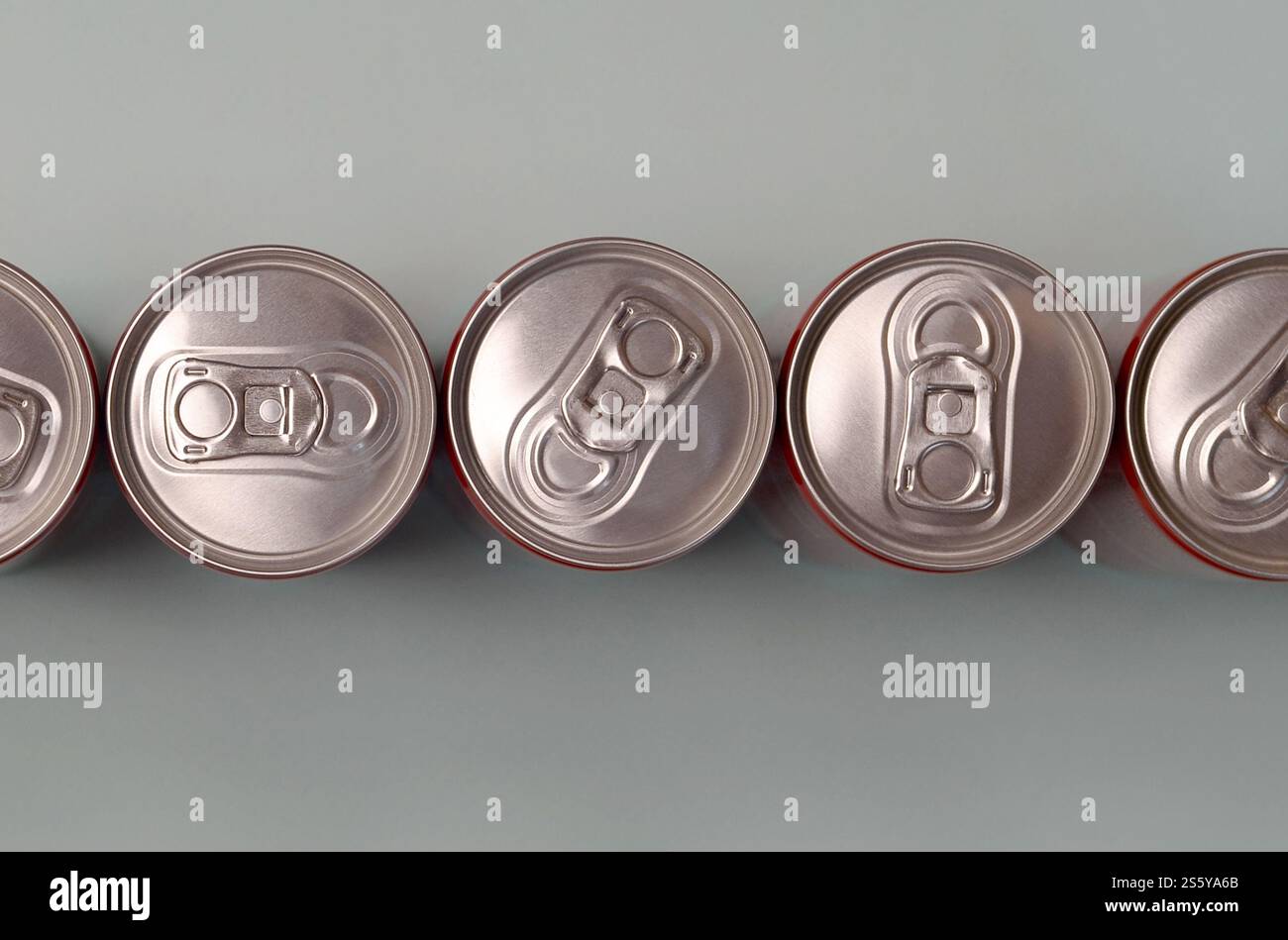 Viele neue Aluminiumdosen mit alkoholfreien Limonaden, Limonade Cola, Bier oder Energy Drink. Konzept der Getränkeherstellung und Massenproduktion. Viele Stockfoto