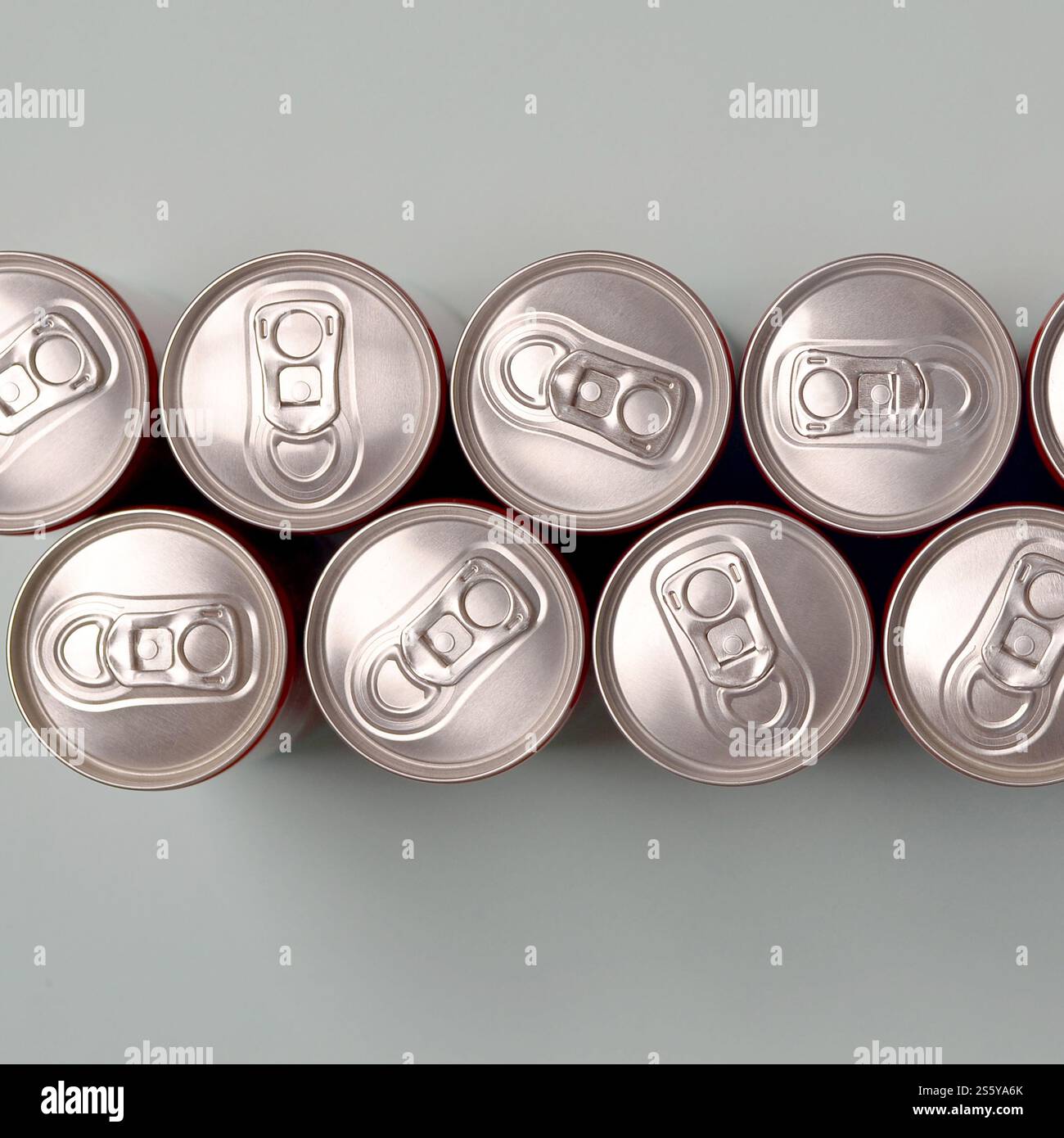 Viele neue Aluminiumdosen mit alkoholfreien Limonaden, Limonade Cola, Bier oder Energy Drink. Konzept der Getränkeherstellung und Massenproduktion. Viele Stockfoto