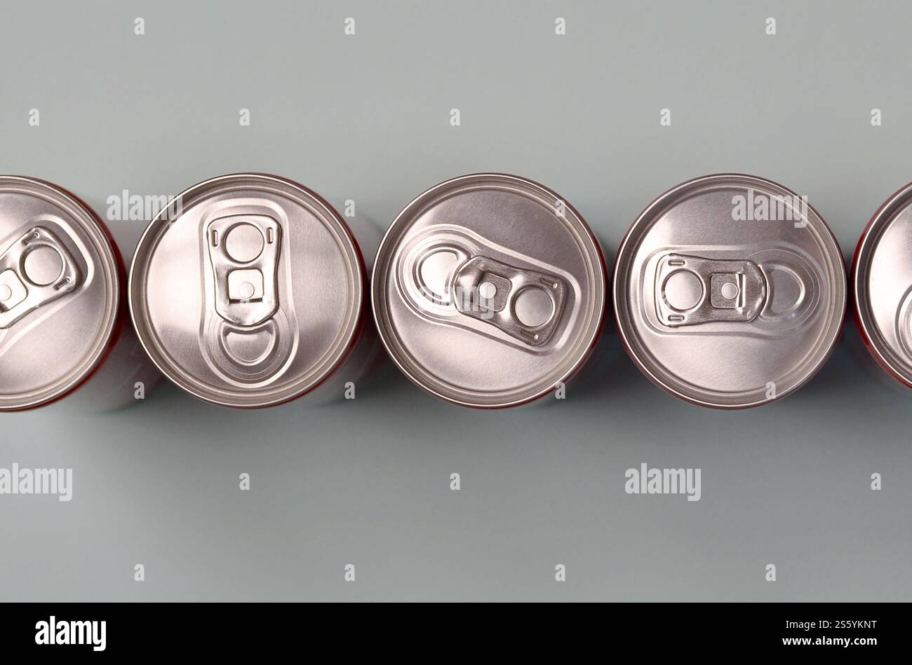 Viele neue Aluminiumdosen mit alkoholfreien Limonaden, Limonade Cola, Bier oder Energy Drink. Konzept der Getränkeherstellung und Massenproduktion. Viele Stockfoto