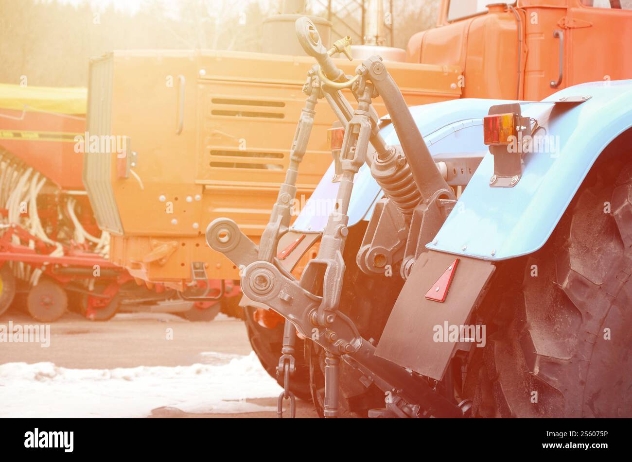 Räder der Rückansicht des neuen Traktors bei Schnee. Rückansicht des landwirtschaftlichen Fahrzeugs. Räder der Rückansicht des neuen Traktors bei Schnee. Stockfoto