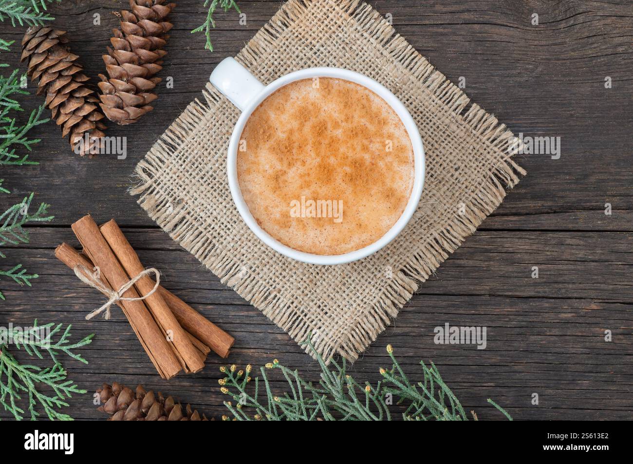 Weiße Tasse salep milky traditionelles Heißgetränk von Truthahn mit Zimtpulver und Stäbchen auf rustikalem Vintage Holztisch. Sahlep-Hintergrund Stockfoto