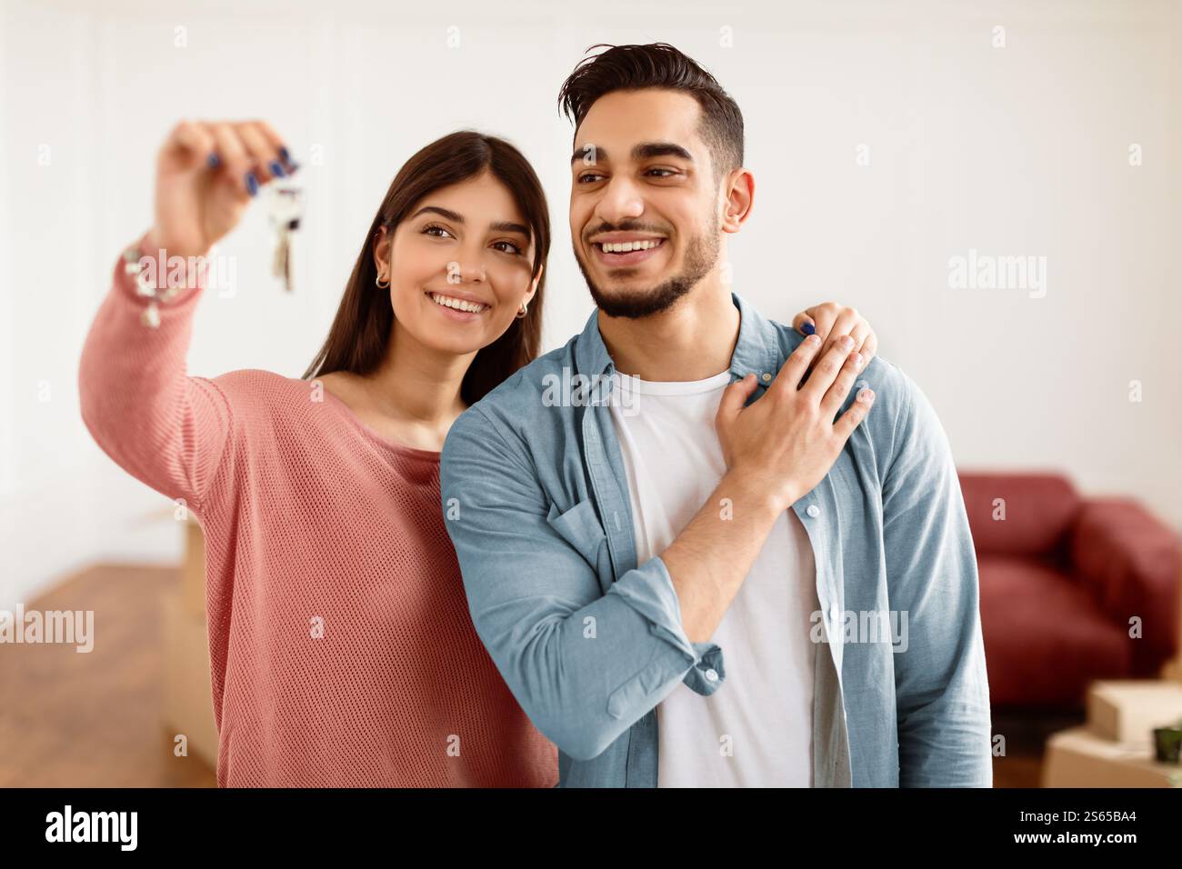 Glückliches Paar, das die Schlüssel ihrer Wohnung zeigte Stockfoto