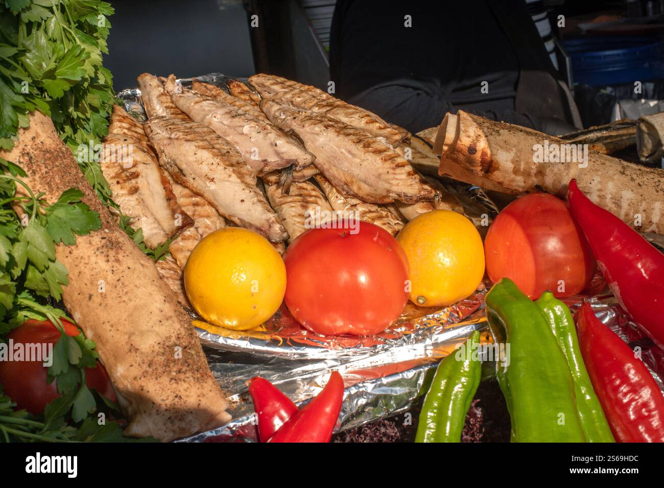 Köstlich aussehende gegrillte Makrele und frisches Gemüse, bereit für die Zubereitung von Balik Ekmek, ein traditionelles türkisches Straßenessen, übersetzt als Fisch und Brot, Kar Stockfoto
