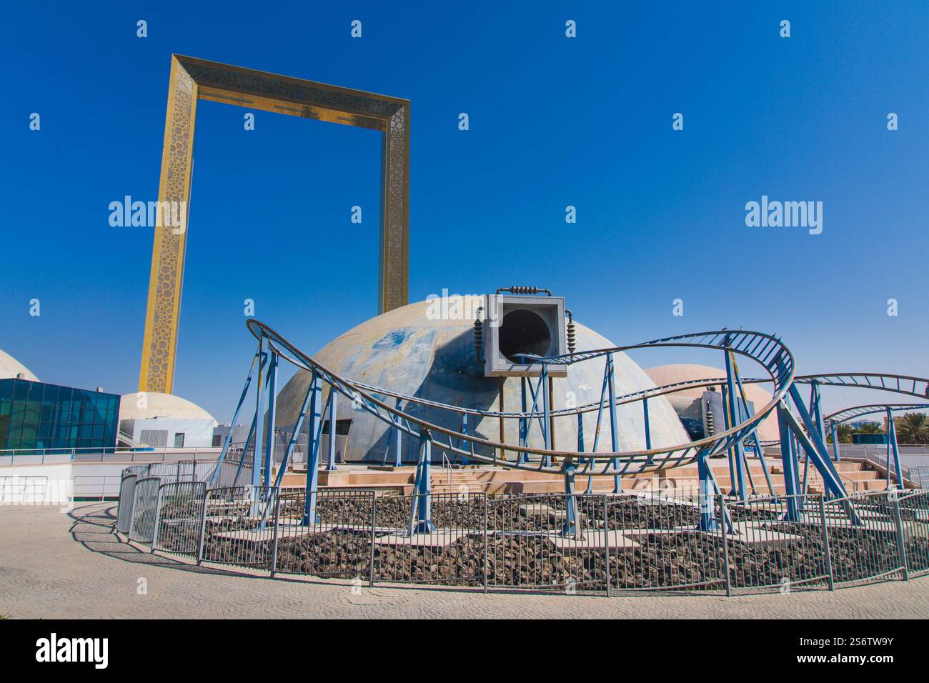 Naher Osten, Vereinigte Arabische Emirate, Dubai, Zabeel Park. Der Rahmen. Im Vordergrund befindet sich der verlassene Vergnügungspark mit seinen Kuppeln, Planeten und Fliegen Stockfoto