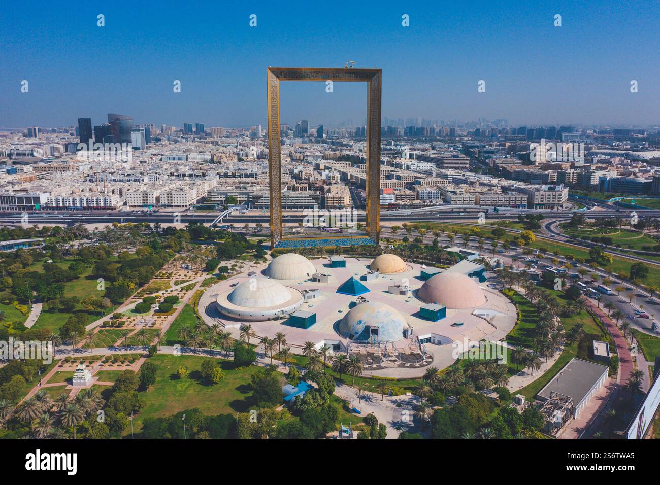Naher Osten, Vereinigte Arabische Emirate, Dubai, Zabeel Park. Der Rahmen. Im Vordergrund befindet sich der verlassene Vergnügungspark mit seinen Kuppeln, Planeten und Fliegen Stockfoto