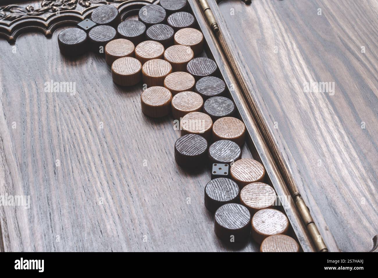 Einzigartige handgefertigte Holzspielstücke, die auf einer Vintage-Tischplatte angeordnet sind Stockfoto