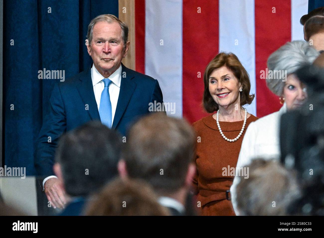 Former President W. Bush, left, and his wife Laura Bush arrive