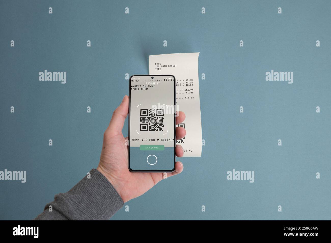 Smartphone scannt einen QR-Code auf einem Papierbeleg auf einem Tisch und veranschaulicht das Konzept der digitalen Bezahlung von Rechnungen mithilfe von Mobiltechnologie Stockfoto