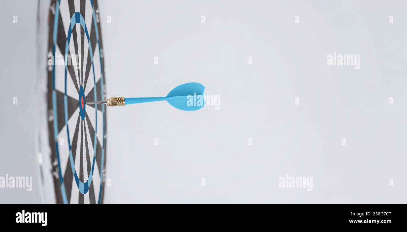 Blauer Pfeil, der in der Mitte eines Ziels eingebettet ist, symbolisiert Erfolg, Präzision und macht die richtigen Schritte, um Ziele effektiv zu erreichen Stockfoto