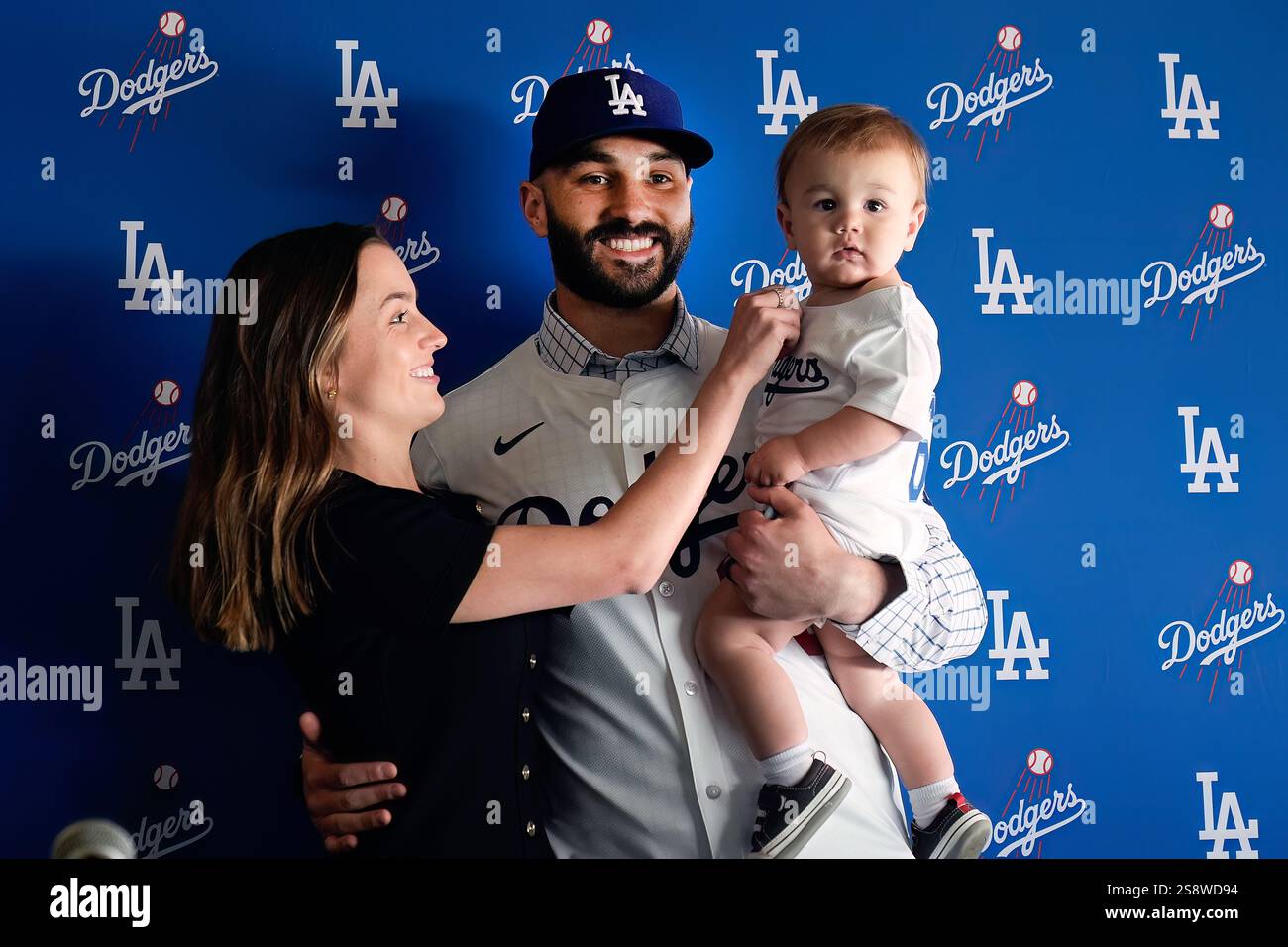 Left-handed reliever Tanner Scott, center, is joined by his wife Maddie ...