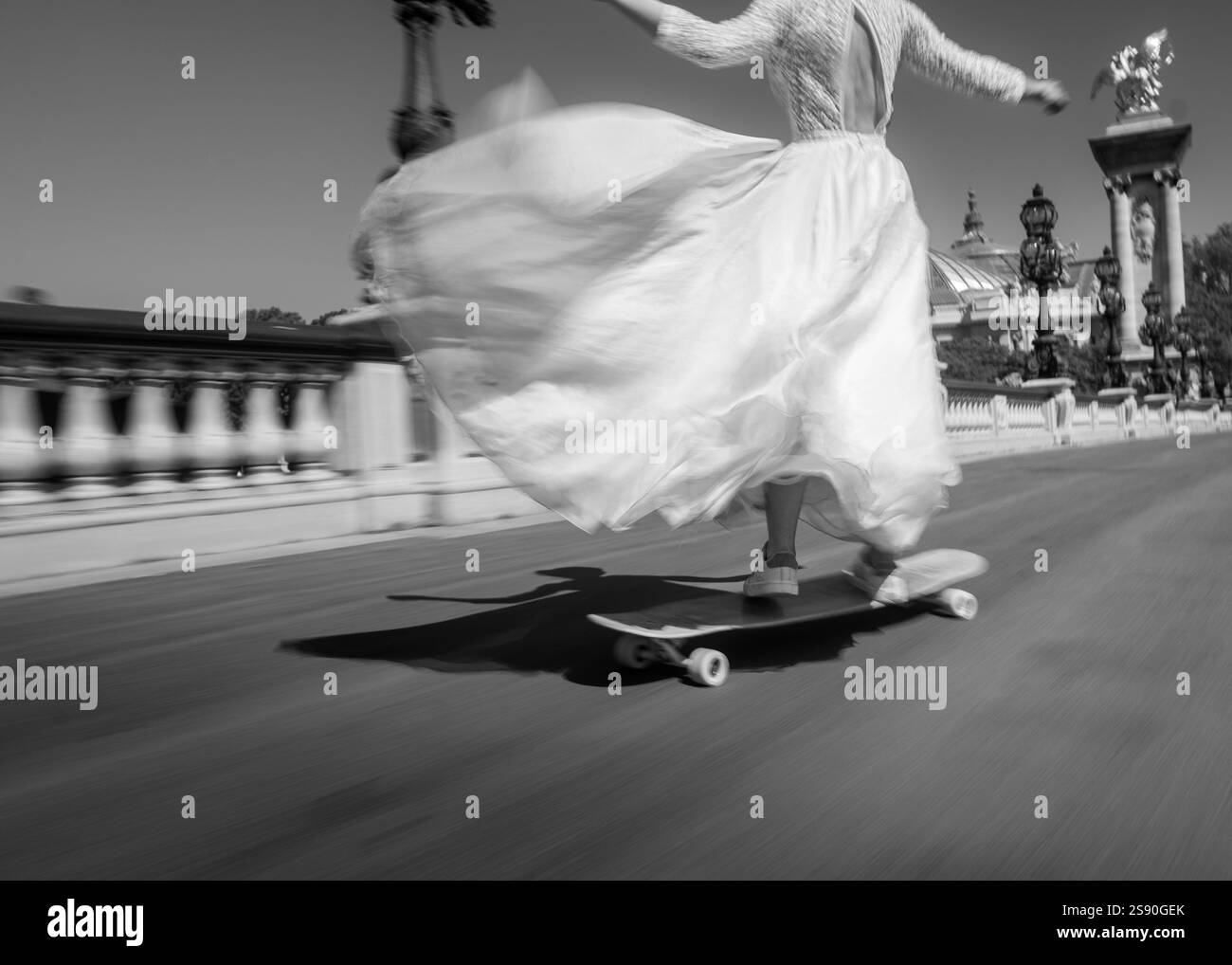 Eine Braut, die durch die Straßen von Paris skateboardet und Freiheit, Eleganz, Sport und Kunst in einem dynamischen Stil der Straßenfotografie vereint. Stockfoto