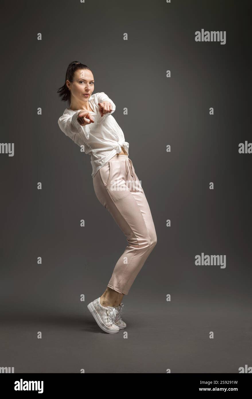 Junge und Schoene Taenzerin posiert im Studio vor farbigem Hintergrund Stockfoto