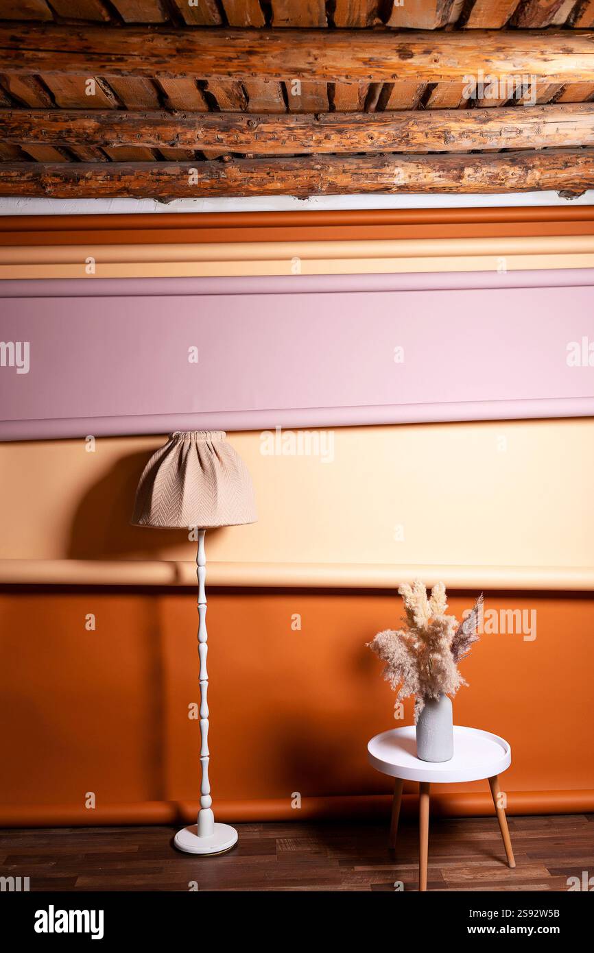 Hohe Lampe mit weißem Tischhintergrund. Fotozone mit Couchtisch im Fotostudio Stockfoto