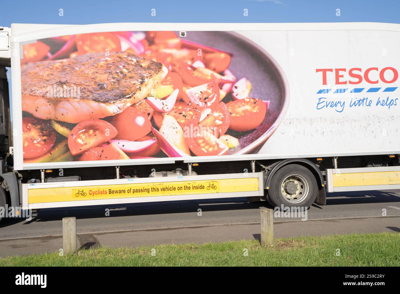 Seitenansicht des TESCO Lieferwagens mit seiner mit roten Tomaten bemalten Seitenverkleidung auf einer Pfanne, auf der Straße in Greenwich England, Großbritannien Stockfoto