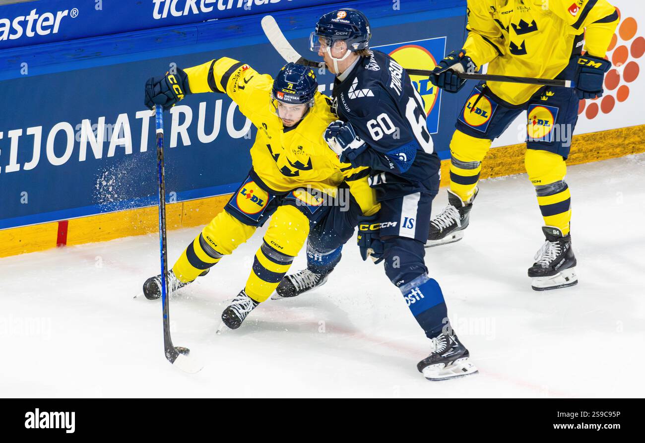 Freiburg, Schweiz, 14. Dezember 2024: #71 Isac Brannstrom (Schweden) muss den Puck in einem Duell gegen #60 Thomson Lassi (Finnland) verteidigen. (Foto von und Stockfoto Freiburg, Schweiz, 14. Dezember 2024: #71 Isac Brannstrom (Schweden) muss den Puck in einem Duell gegen #60 Thomson Lassi (Finnland) verteidigen. (Foto von und Stockfoto