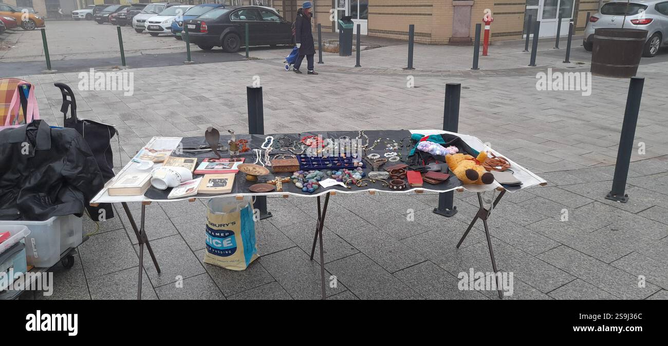 Europäischer Antiquitätenmarkt, Stand am Flohmarkt : farbenfrohe Kristallsteine, Kristallschmuck, Bernsteinketten, Vintage-Spielzeug, Vintage-Bücher, Vintage Rosenkranzperlen, Naturstein- und Mineralhalsketten, Edelsteinanhänger, Vintage Medaillen, Vintage Lederbrieftaschen, Vintage Gusseisenschere, Vintage Lederhandschuhe, Vintage Modeschmuck, Vintage Kreuz Stockfoto