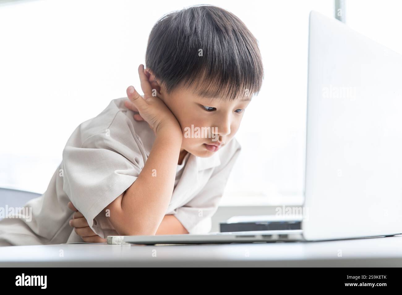 Kind, das einen Computer bedient Stockfoto