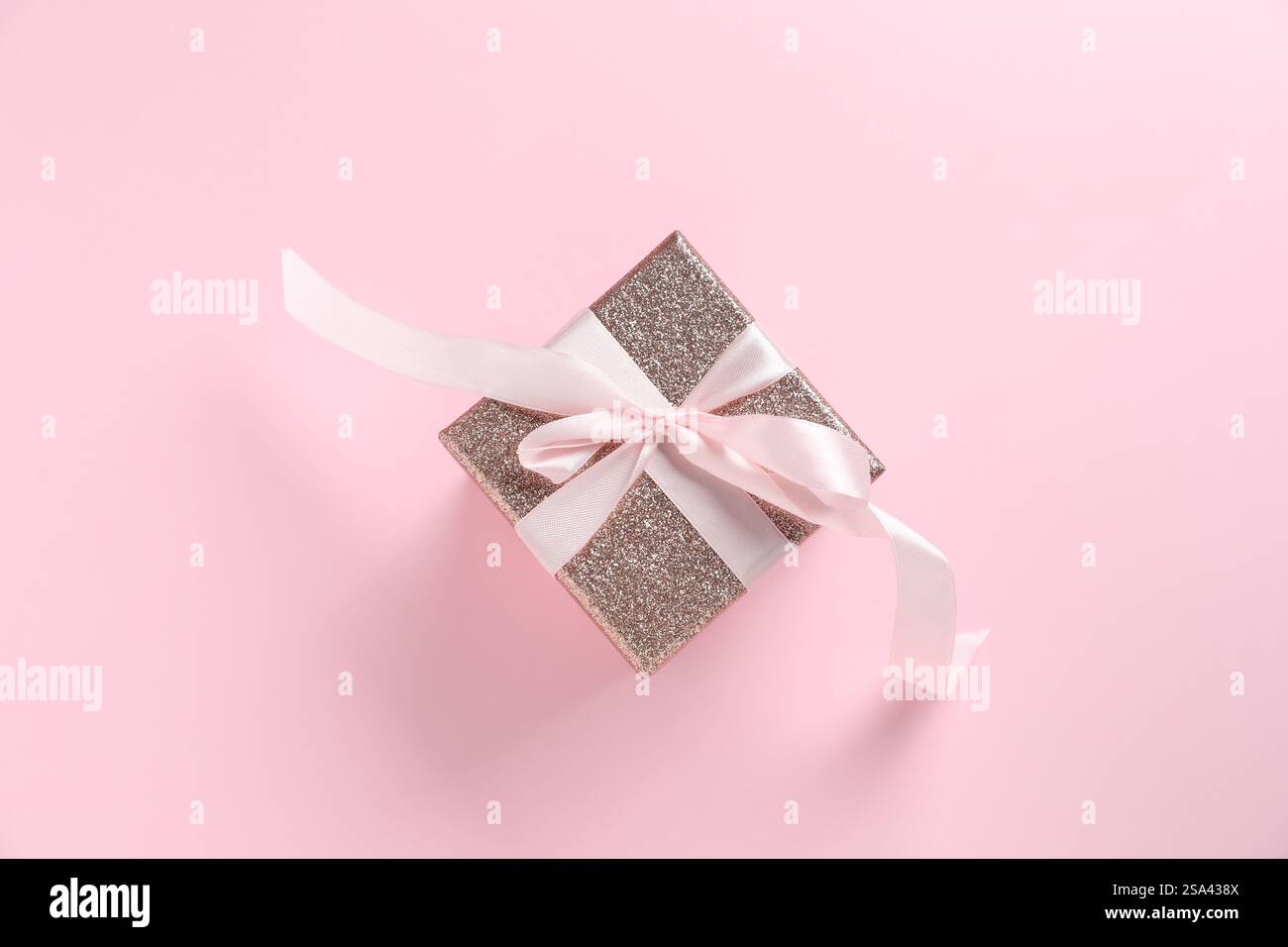 Romantisches Geschenk auf hellrosa Hintergrund, Draufsicht Stockfoto