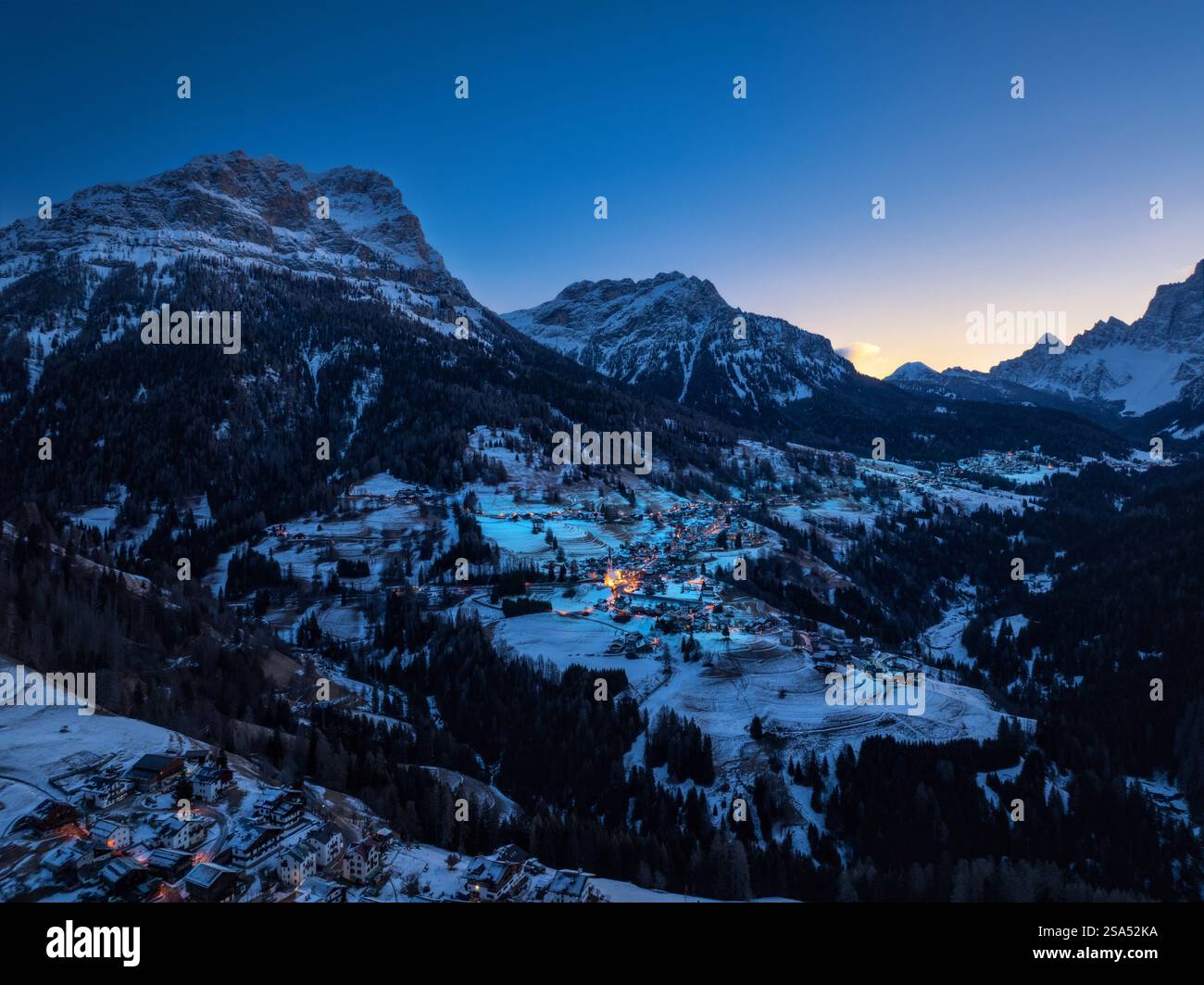 Aerial drone view of the Selva di Cadore comune illuminated at night in the province of Belluno, Dolomites, Italy Stockfoto