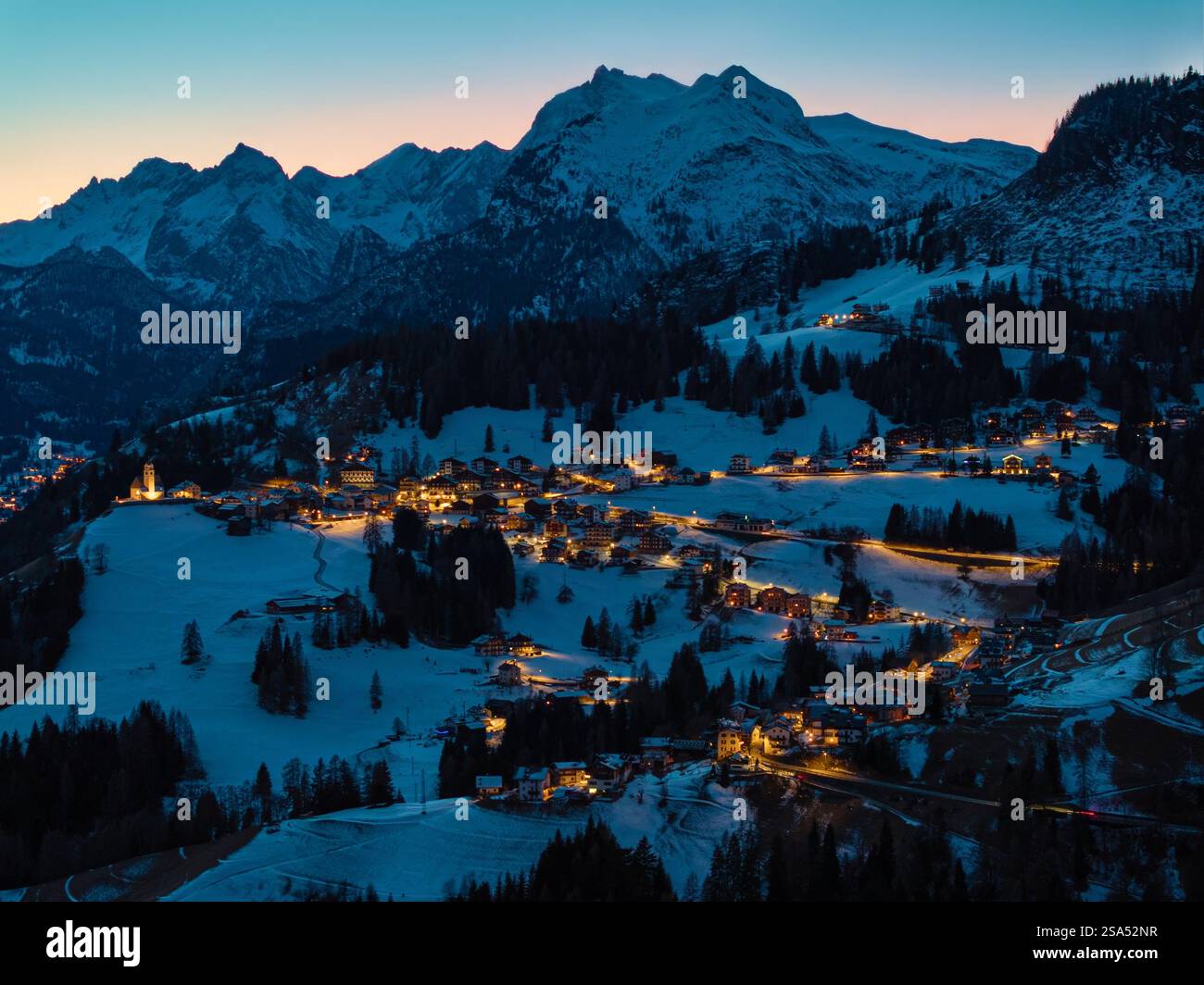 Aerial drone view of the Colle Santa Lucia commune in the Province of Belluno, Dolomites, Italy, illuminated in the evening Stockfoto