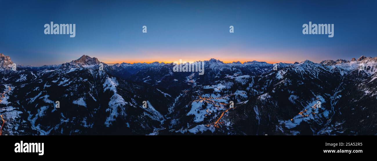 Aerial drone panorama of the Colle Santa Lucia commune in the Province of Belluno, Dolomites, Italy, illuminated in the evening Stockfoto