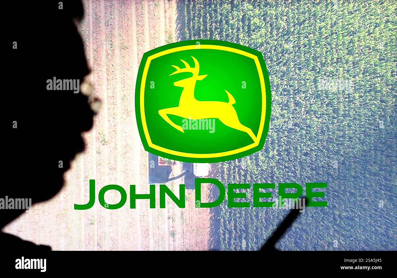 In dieser Abbildung wird das Logo von Deere & Company im Hintergrund angezeigt. Stockfoto